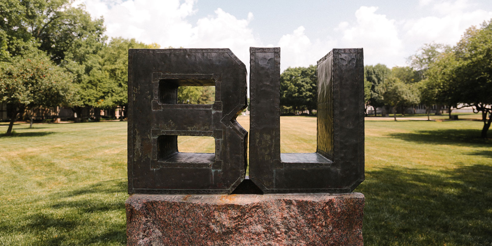 Large BU metal sign on college grounds